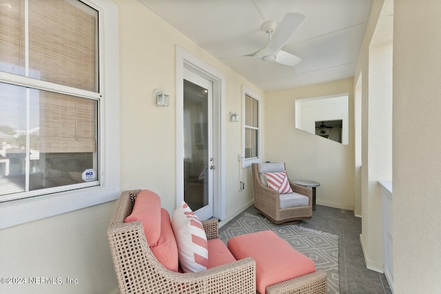 sunroom featuring ceiling fan