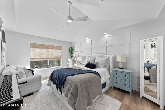 bedroom featuring light wood-type flooring, ceiling fan, and vaulted ceiling