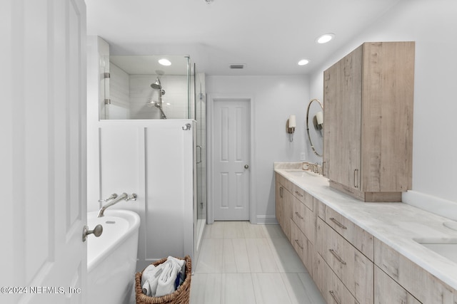 bathroom with independent shower and bath, vanity, and tile patterned flooring