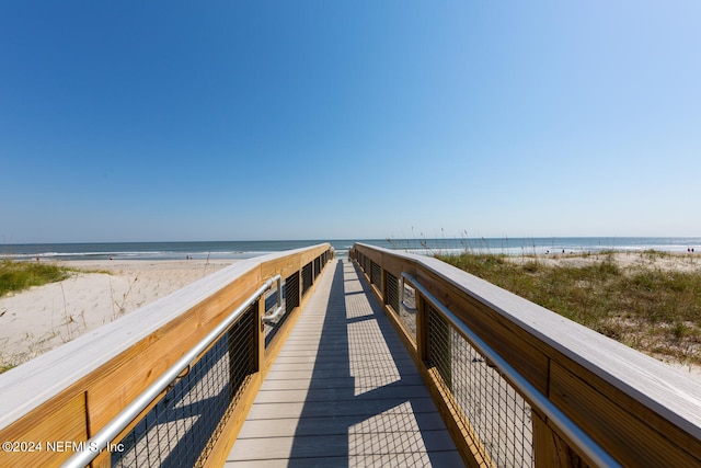 view of community featuring a beach view and a water view