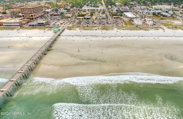 aerial view with a water view and a beach view