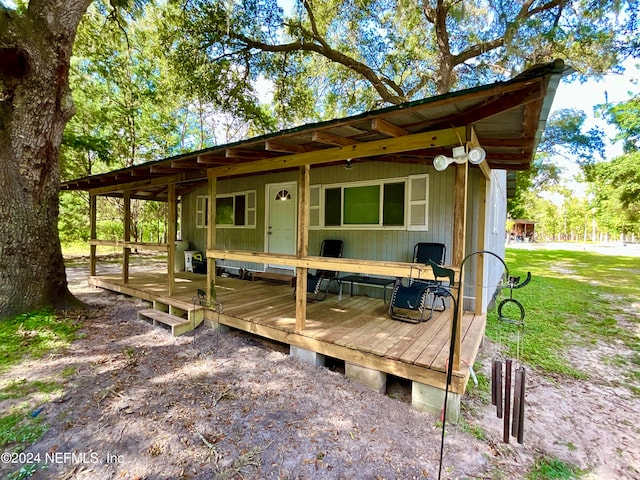 exterior space featuring a deck and a lawn