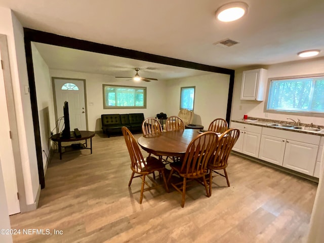 dining room with ceiling fan, a wealth of natural light, sink, and light hardwood / wood-style floors