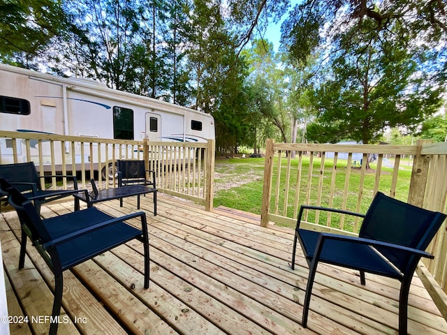 wooden deck featuring a yard