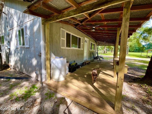 exterior space with ceiling fan and a deck