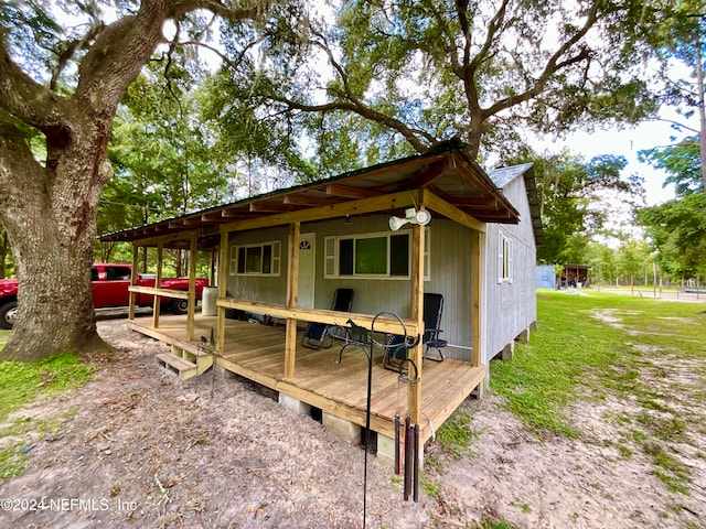 view of property exterior featuring a deck and a yard