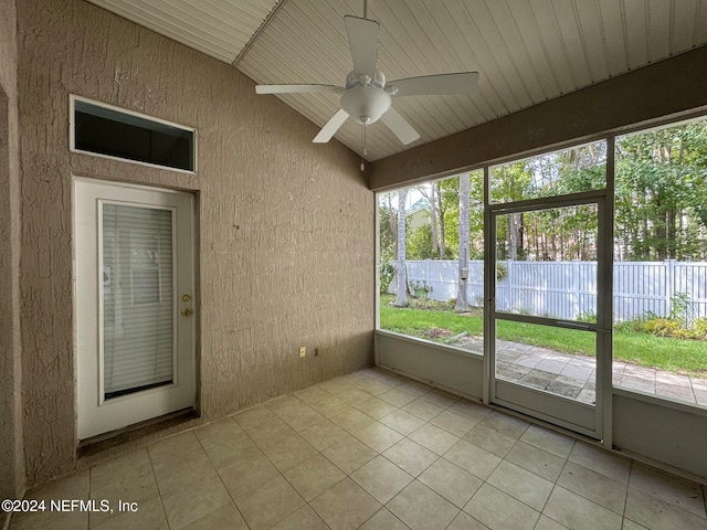 unfurnished sunroom featuring ceiling fan and lofted ceiling