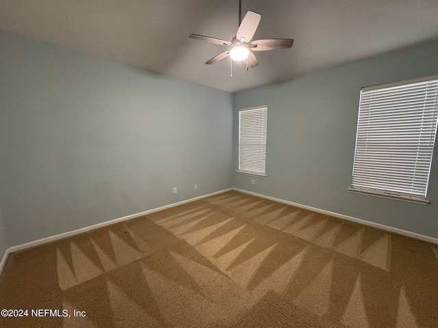 empty room featuring carpet flooring and ceiling fan