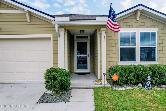 view of exterior entry featuring a garage