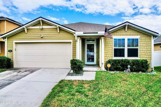 view of front of house featuring a garage and a front lawn