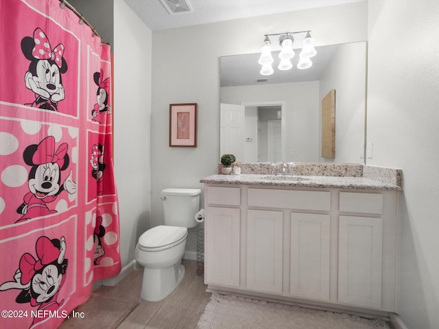 bathroom with vanity, a shower with shower curtain, toilet, and tile patterned flooring