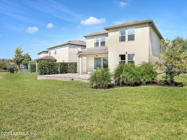 back of property featuring a patio and a lawn