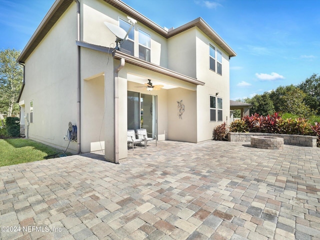 rear view of property featuring a patio and ceiling fan