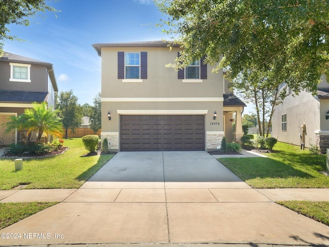 view of front facade featuring a front yard and a garage