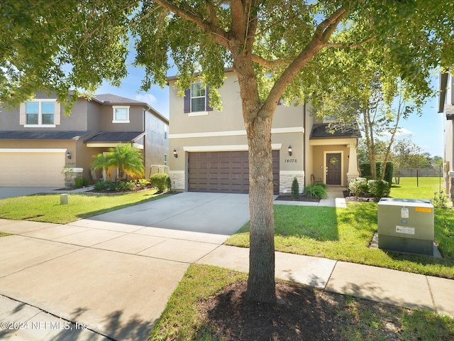 view of front of house featuring a front yard and a garage