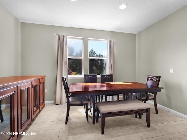 dining space featuring a textured ceiling