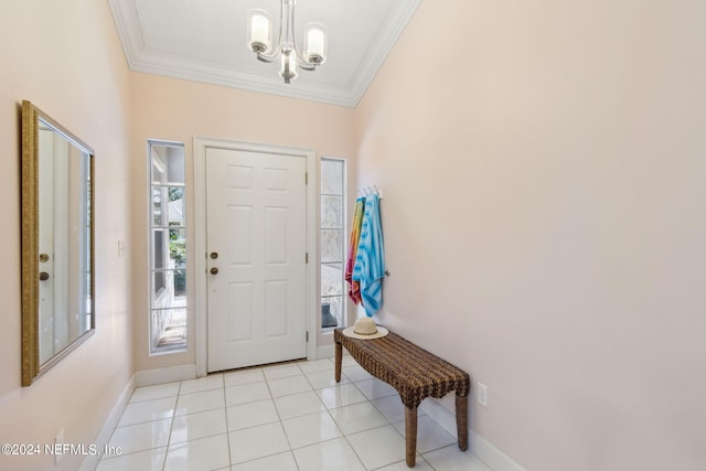 tiled entryway featuring ornamental molding and a chandelier