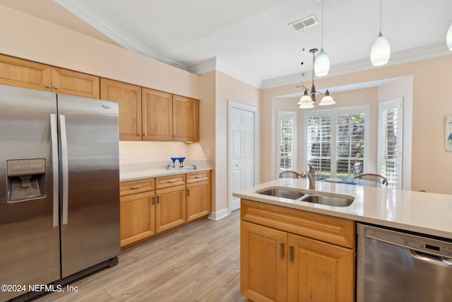 kitchen featuring appliances with stainless steel finishes, sink, light wood-type flooring, pendant lighting, and crown molding