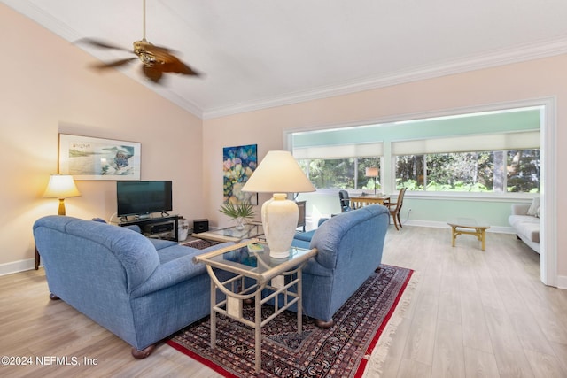 living room featuring vaulted ceiling, light hardwood / wood-style flooring, crown molding, and ceiling fan