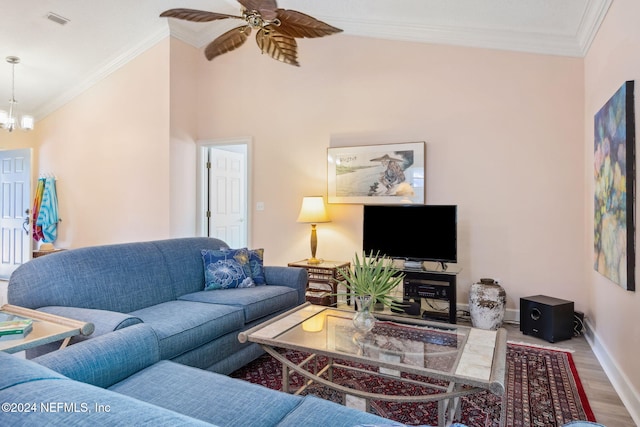 living room featuring crown molding, hardwood / wood-style flooring, lofted ceiling, and ceiling fan with notable chandelier