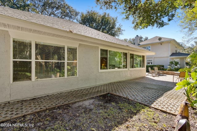 view of side of home with a patio area