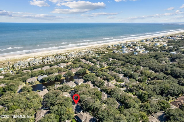 birds eye view of property with a water view and a view of the beach