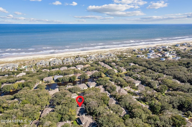 bird's eye view with a water view and a beach view