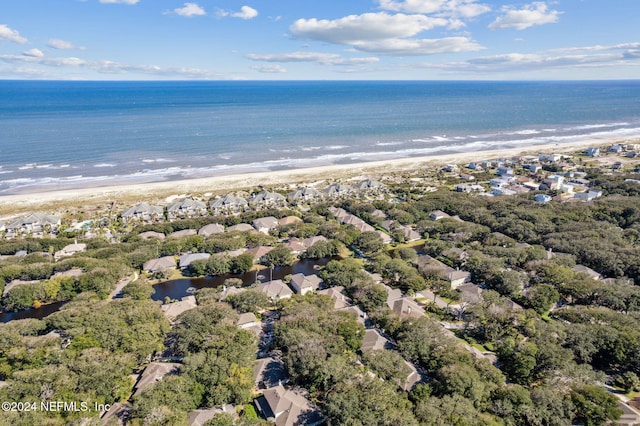 birds eye view of property featuring a water view and a beach view