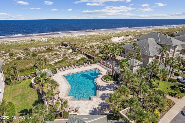 drone / aerial view featuring a view of the beach and a water view