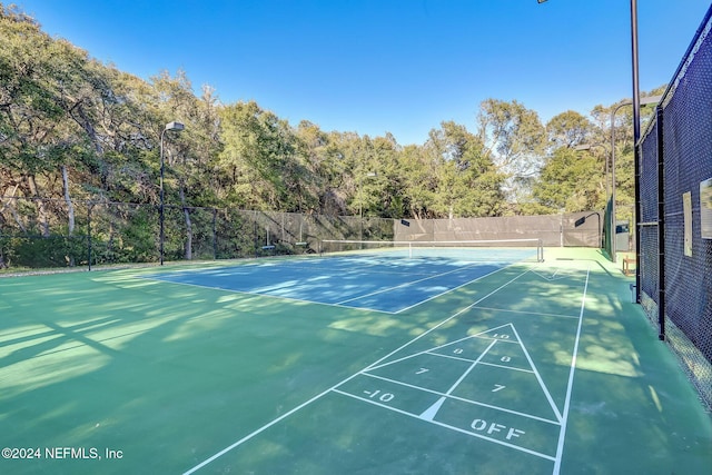 view of property's community featuring tennis court