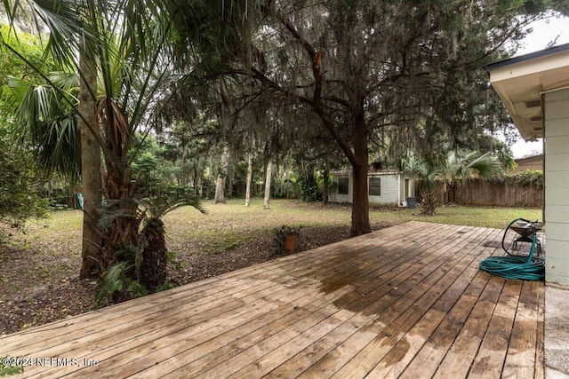 wooden deck featuring a storage shed