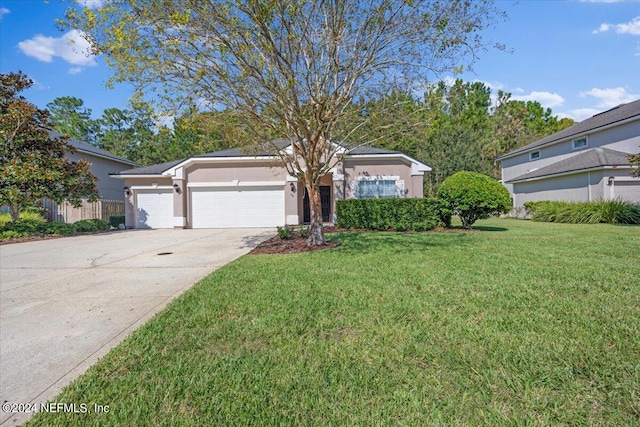 view of front of property featuring a front lawn and a garage