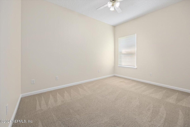 carpeted empty room with a textured ceiling and ceiling fan