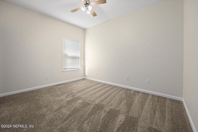 unfurnished room featuring ceiling fan, a textured ceiling, and carpet