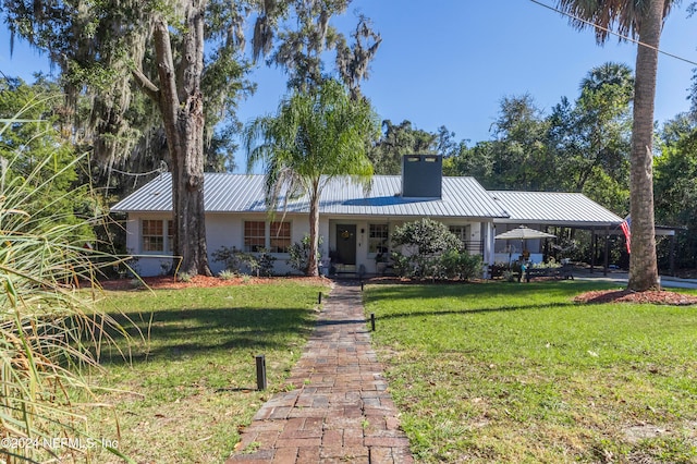 single story home with a front lawn and a carport