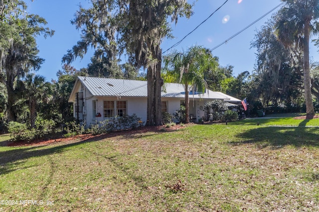 view of home's exterior with a lawn