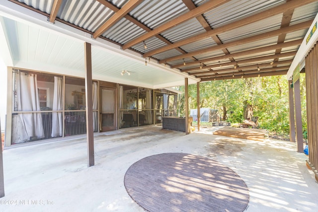 view of patio with an outdoor living space and a sunroom