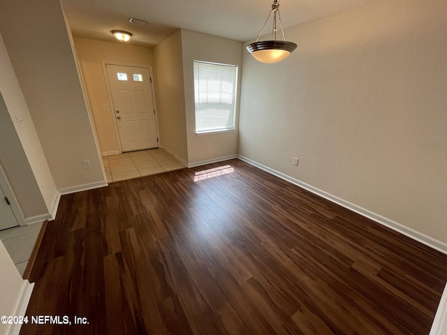 entryway featuring wood finished floors and baseboards