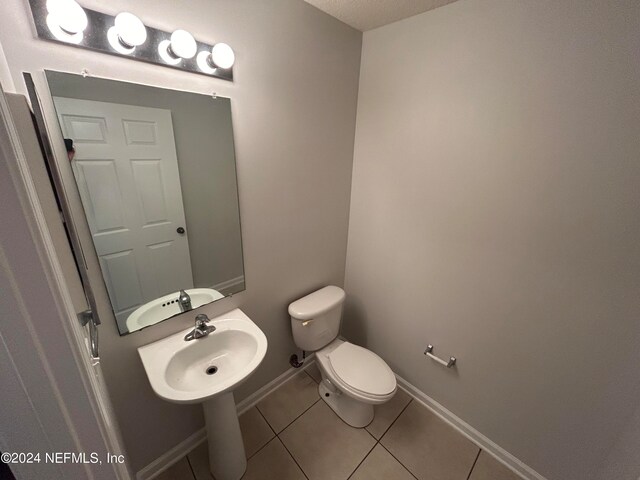 bathroom featuring tile patterned flooring, sink, and toilet