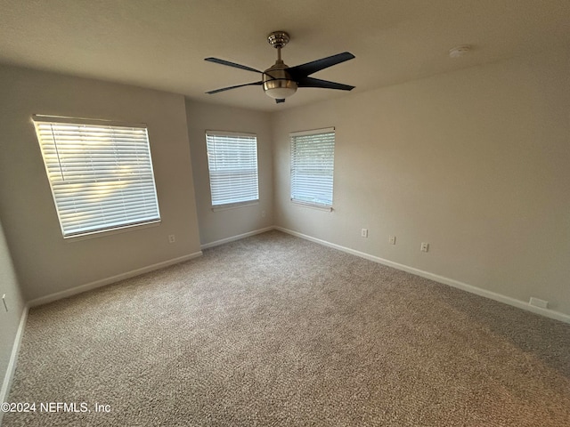 carpeted empty room with ceiling fan