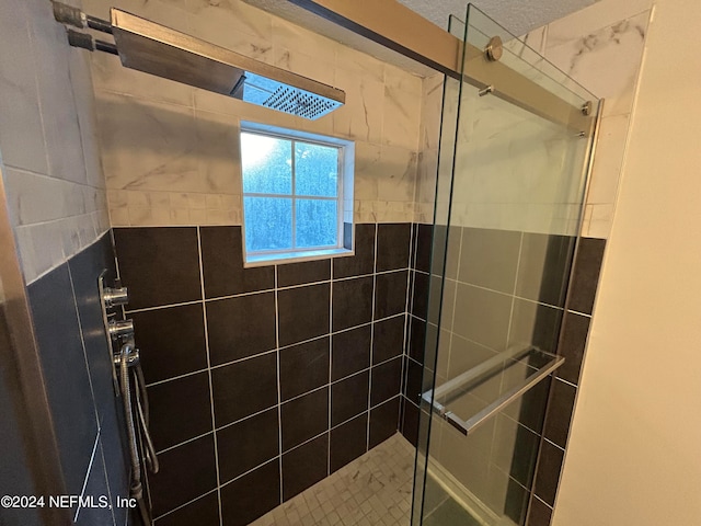 bathroom with tiled shower