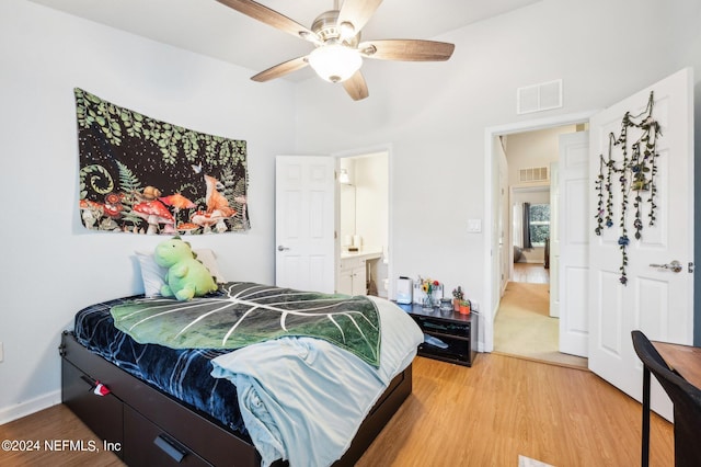 bedroom featuring hardwood / wood-style floors, ensuite bath, and ceiling fan