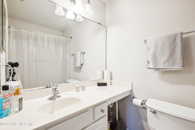 bathroom featuring vanity, toilet, and a shower with shower curtain