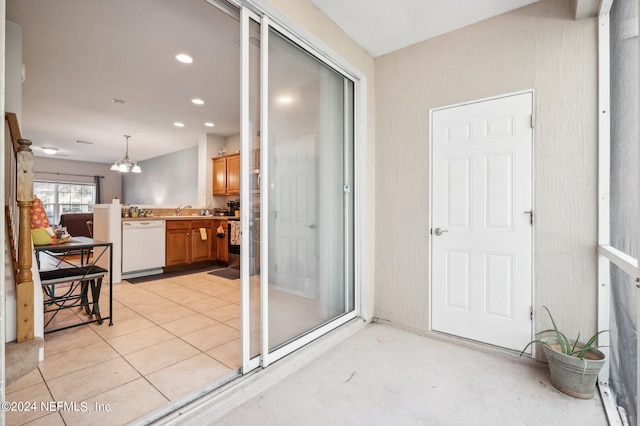 interior space featuring vanity, an inviting chandelier, tile patterned flooring, and a shower with door