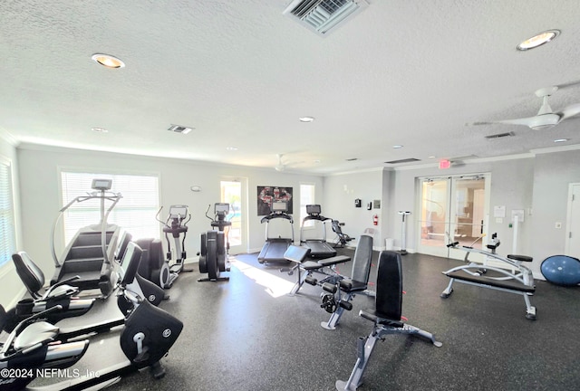 gym featuring crown molding and a textured ceiling