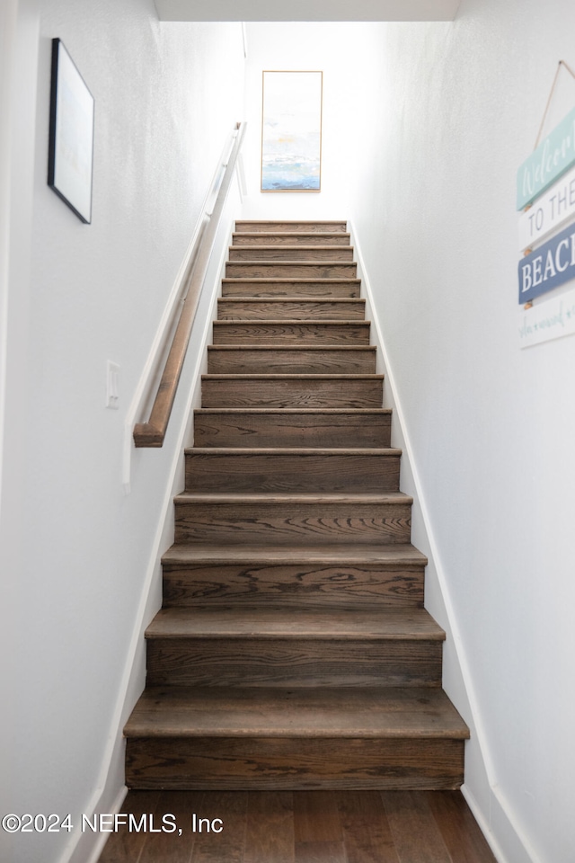 staircase featuring hardwood / wood-style flooring