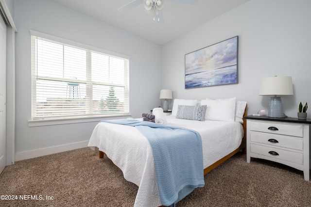 carpeted bedroom featuring a closet and ceiling fan