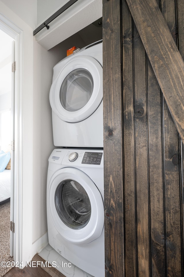 laundry area with stacked washing maching and dryer