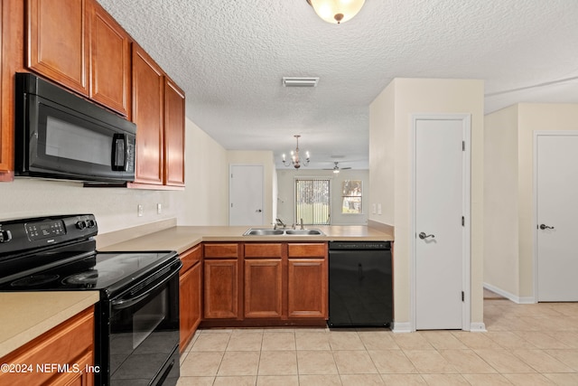 kitchen featuring black appliances, kitchen peninsula, sink, and light tile patterned flooring