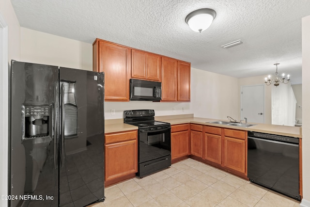 kitchen with a textured ceiling, sink, black appliances, and a notable chandelier